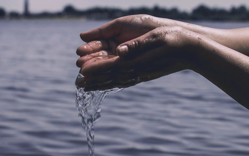 Hands holding clear spiral water